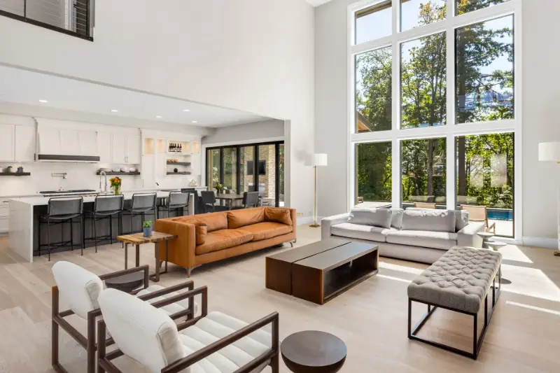 Tall picture windows in a bright open living room