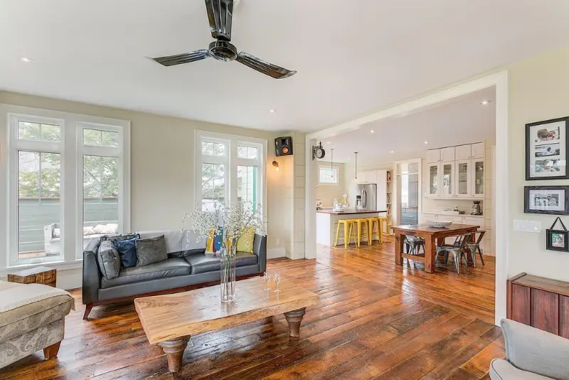 Tall white casement windows in an open Niagara living room