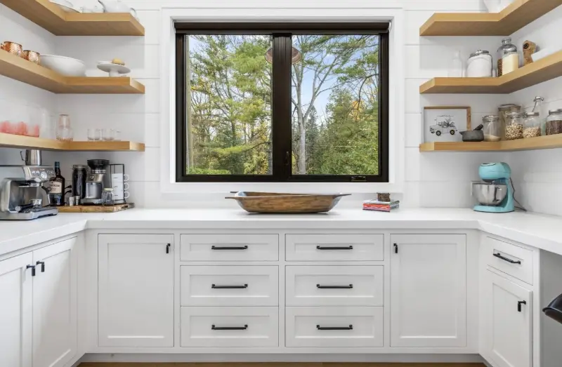 Black sliding window in a white pantry